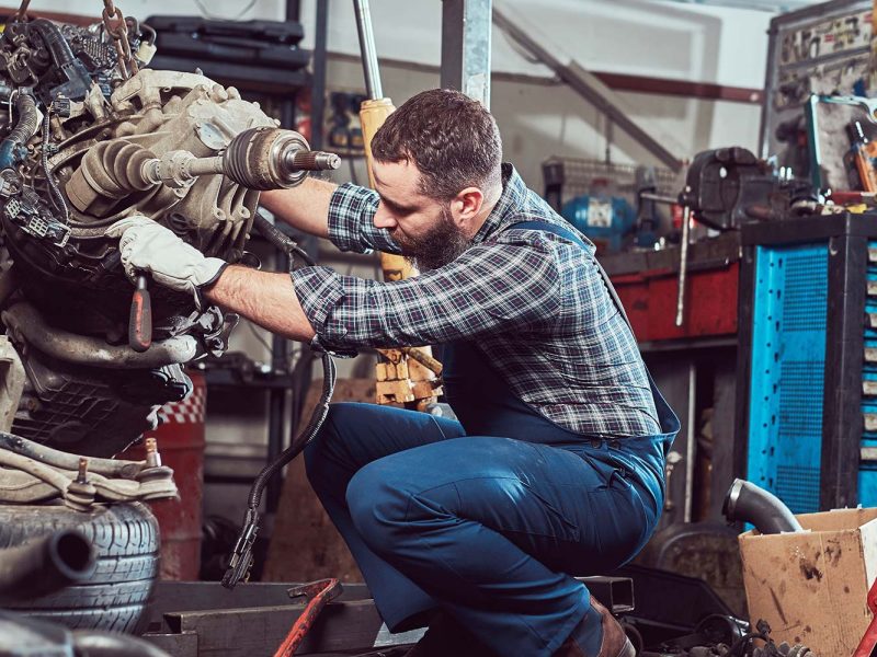 brutal-tattooed-mechanic-repairs-the-car-engine-in-small.jpg